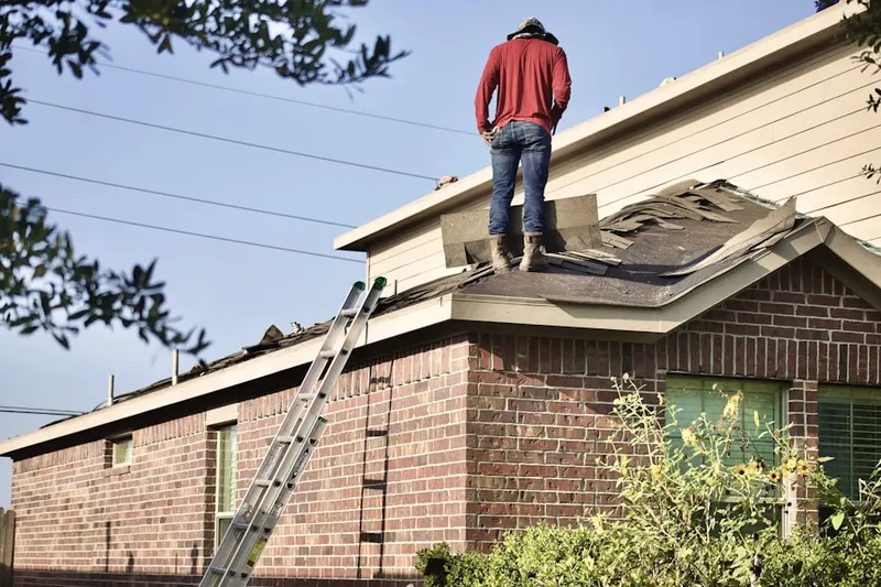 Professional roofer working on a residential roof in Confluence